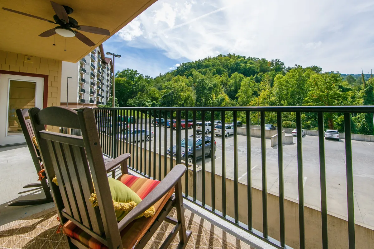 A serene balcony scene with classic rocking chairs overlooking expansive mountain views, inviting guests to relax and soak in nature. The atmosphere is tranquil, ideal for enjoying a sunrise, a quiet coffee, or stargazing after a day of activities.